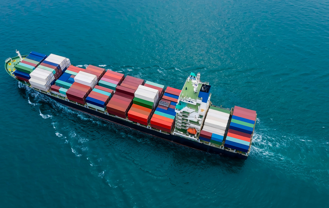Top view of a business container cargo ship in import export business commercial trade logistic which a containers in a harbor of the sea
